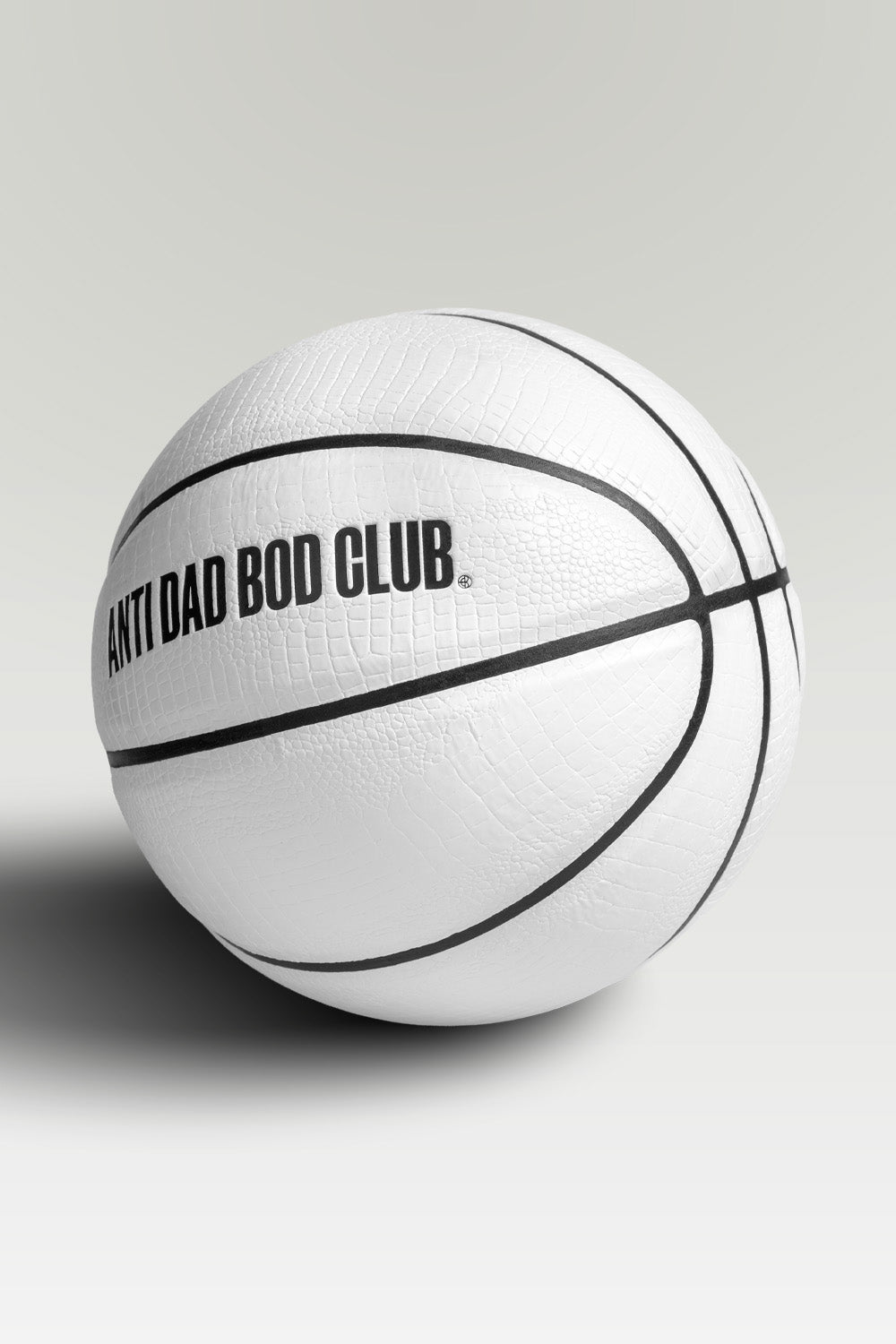 White textured basket ball with 'Anti Dad Bod Club' text on a light gray background