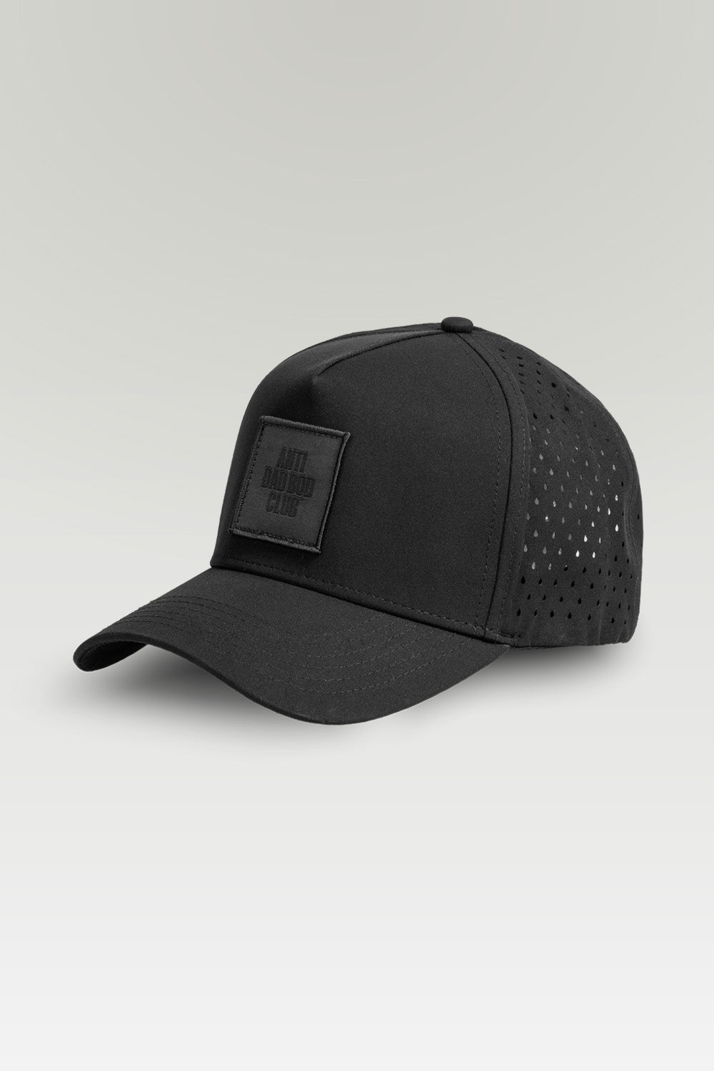 Black baseball cap with a patch on a light gray background